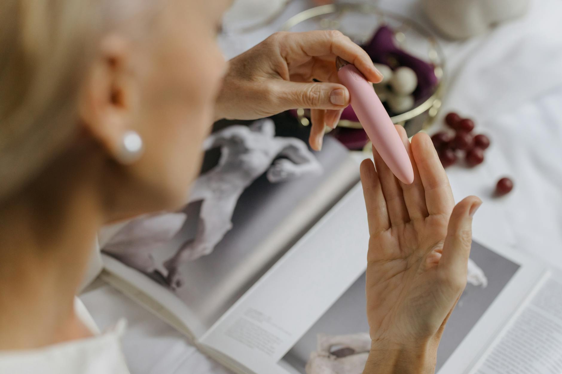 Close-up of a hand holding a vibrator, emphasizing intimate personal recovery and reconnection with pleasure.