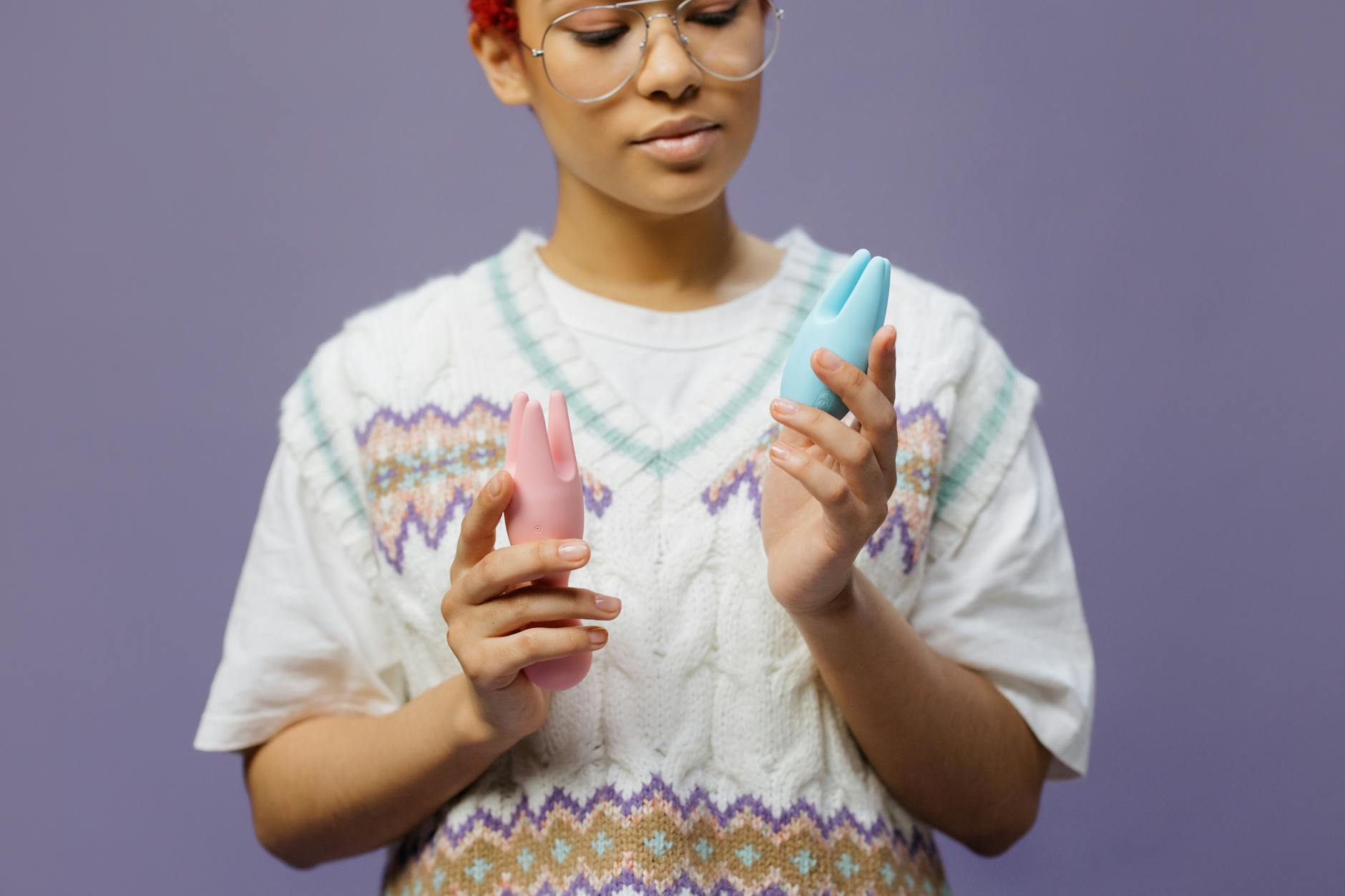 Woman holding lemon clitoral vibrators, reconnecting with her body through touch and sensation.