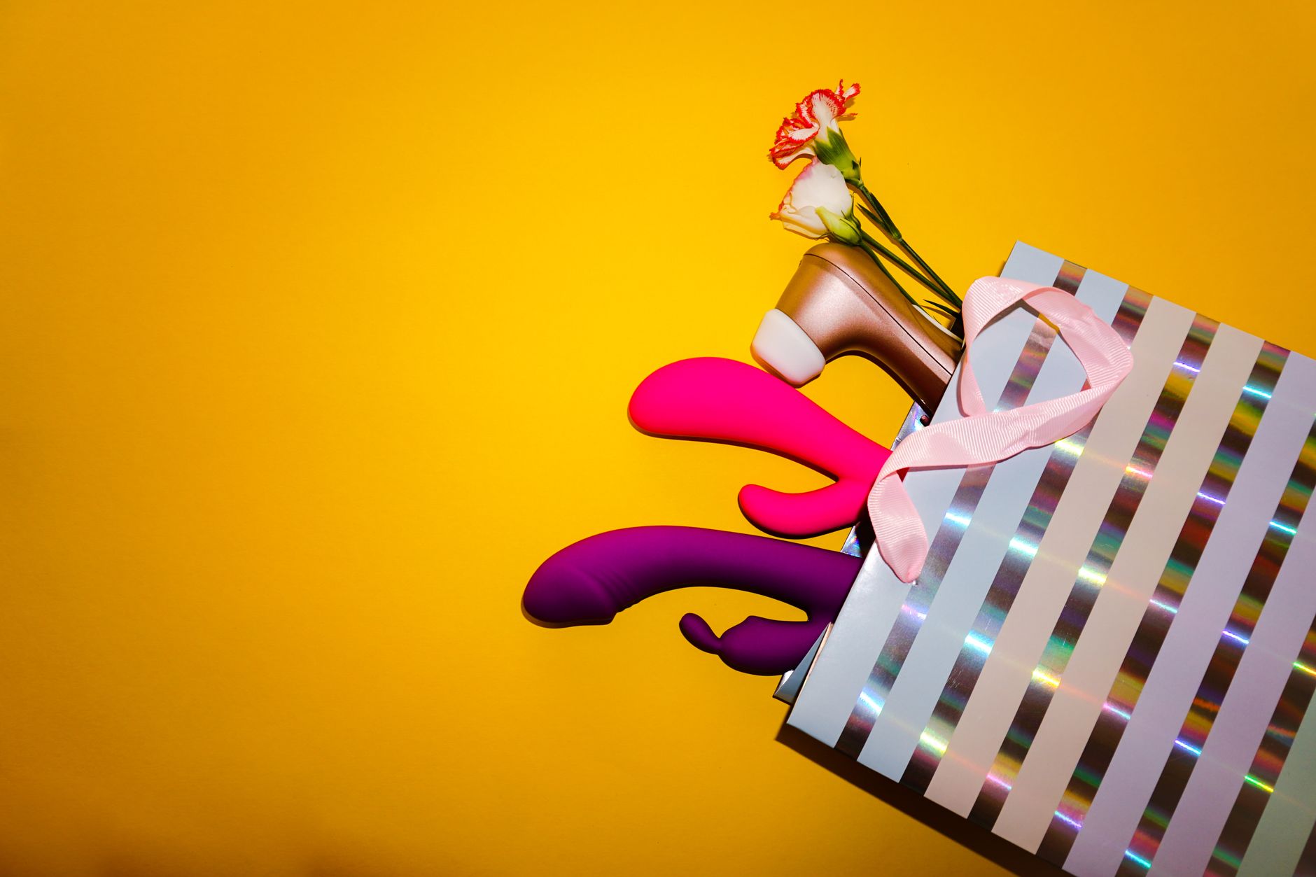Colorful vibrators displayed on a bright background, symbolizing sexual wellness and pleasure